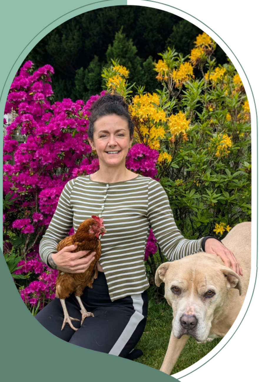 Kelly of The Wee Homekeeper with a hen and a dog in a Dumfries garden